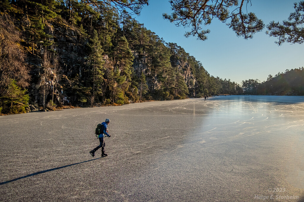 Ice skating on a frozen lake by helstor365