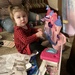 My great great niece 16 months opening some early Christmas gifts.   by illinilass