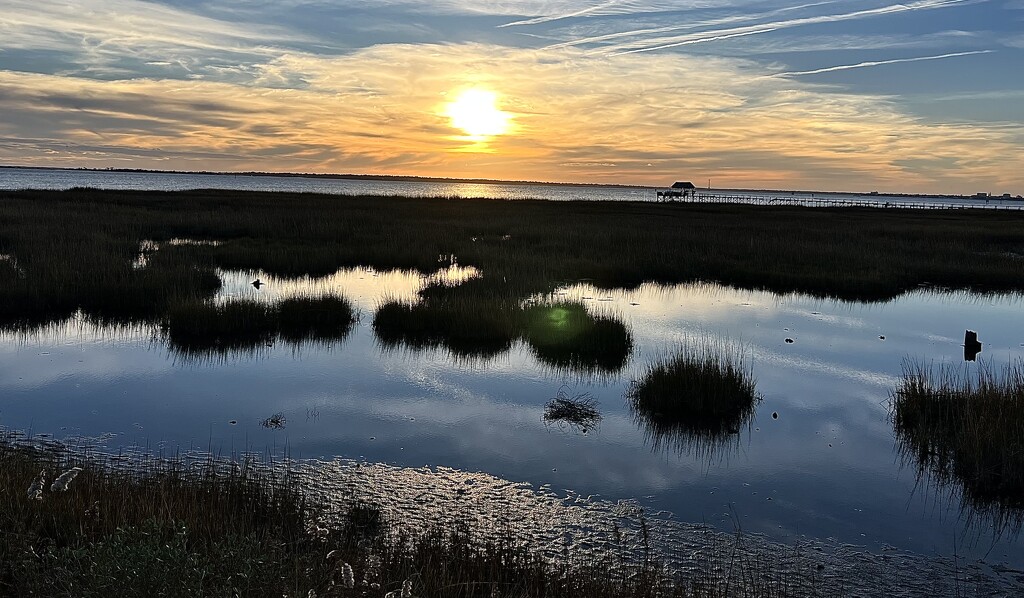 Marsh sunset and Charleston Harbor in the distance. by congaree