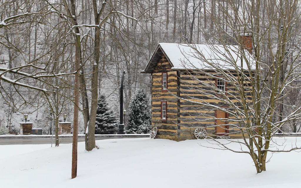 Log house in the snow by mittens