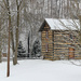 Log house in the snow by mittens