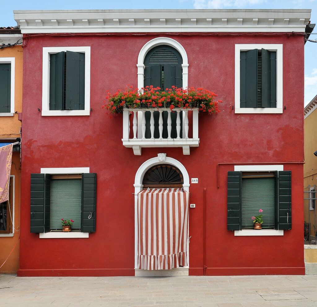 house with red curtain Burano by brigette