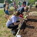 Teaching kids how to plant flowers and vegetables