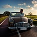 A classic car with driver on a Dutch country road by mastermek