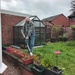 Paul strimming the back garden lawn.