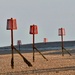 Navigation markers at low tide.