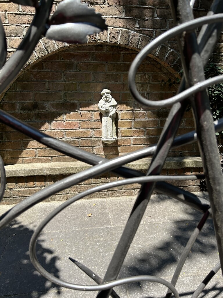 Pilgrim behind ornate gate by swagman