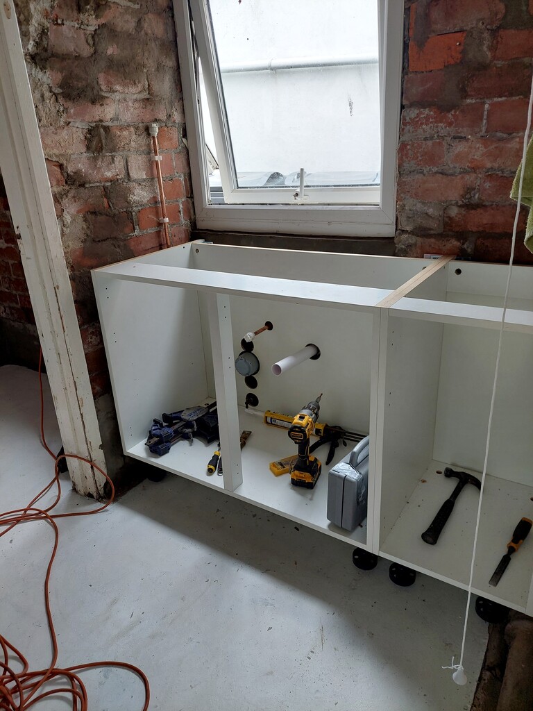 The cupboard unit and plumbing going in by samcat