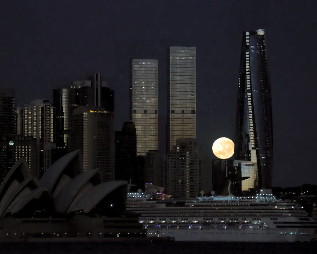 The setting moon between two Sydney skyscrapers.  by johnfalconer