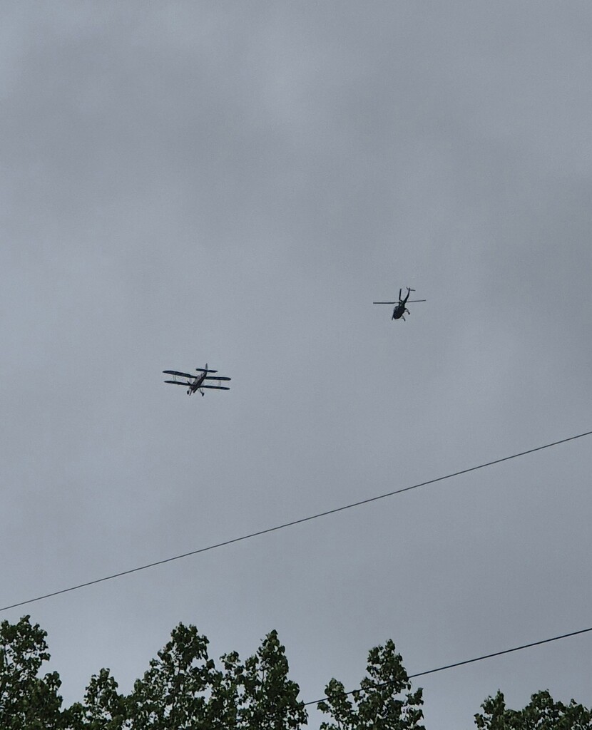 Bi-plane escorted by a helicopter  by happyteg