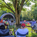 A group of mostly seniors enjoys a community concert from the top of the hill on a Sunday evening. by ggshearron