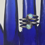 24th Aug 2024 - Opal and silver ring on blue glass hand, detail