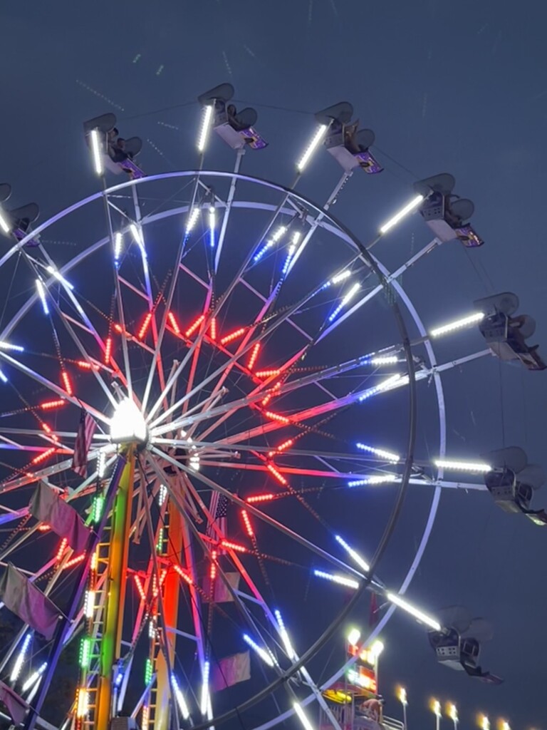 Ferris wheel against the dusk sky by sjgiesman