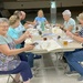 Master Gardeners packaging seeds to sell by tunia