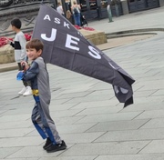 26th Aug 2024 - Day 249/366. A young child with a flag saying Ask me about Jesus.  