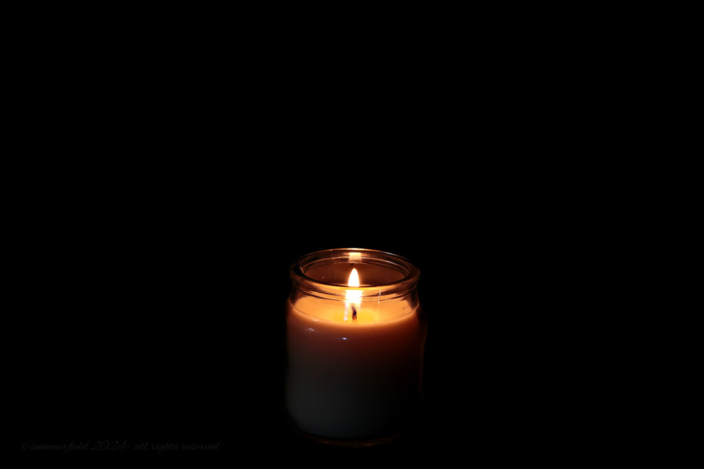 a candle glows - a haiku by summerfield