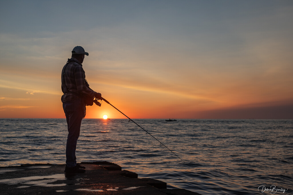 Fishing off the pier in Grand Haven, MI by dridsdale