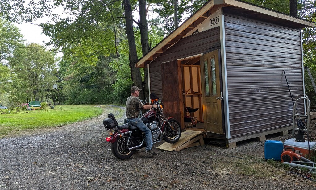 Putting Motorcycle in Shed by julie