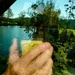 View from train window blocked by selfie of my hand.  by johnfalconer