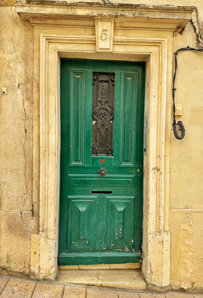 Red heart on green door.  by cocobella