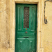 Red heart on green door. 