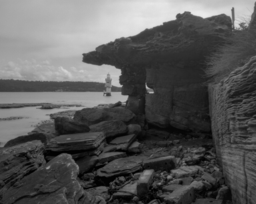 Harbour light and stone structure by peterdegraaff