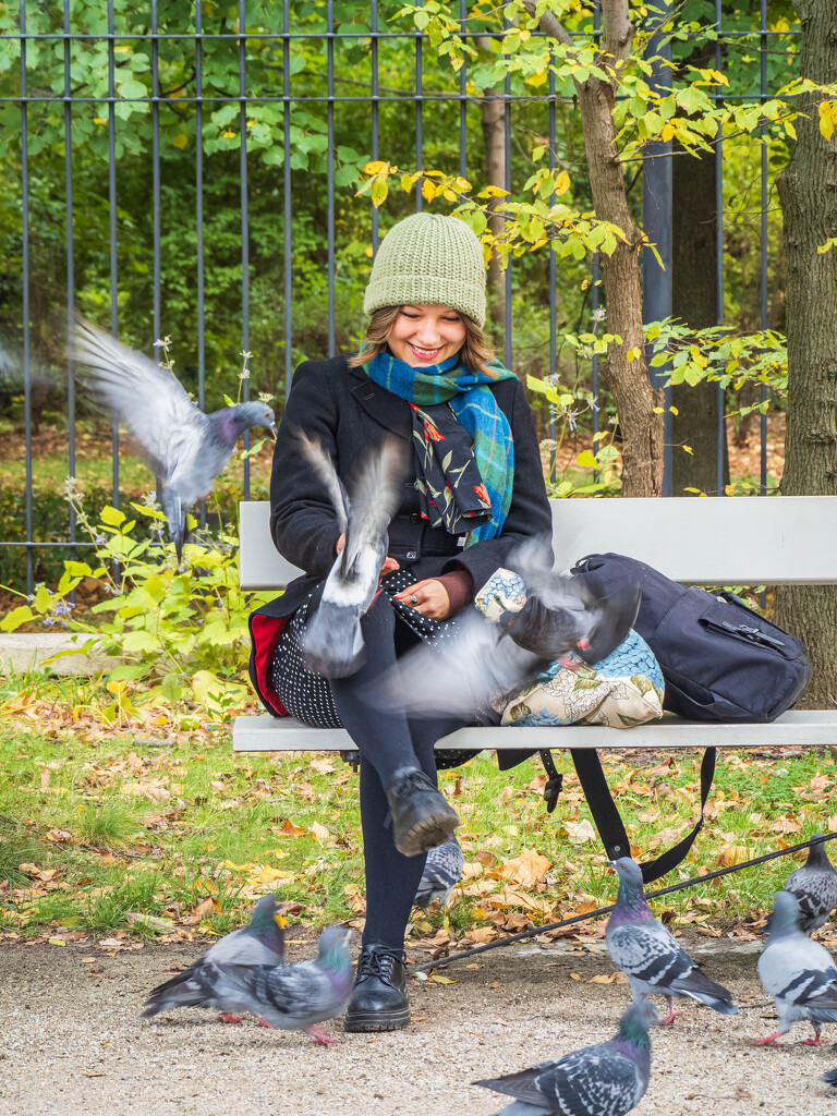 Girl feeding pigeons by haskar