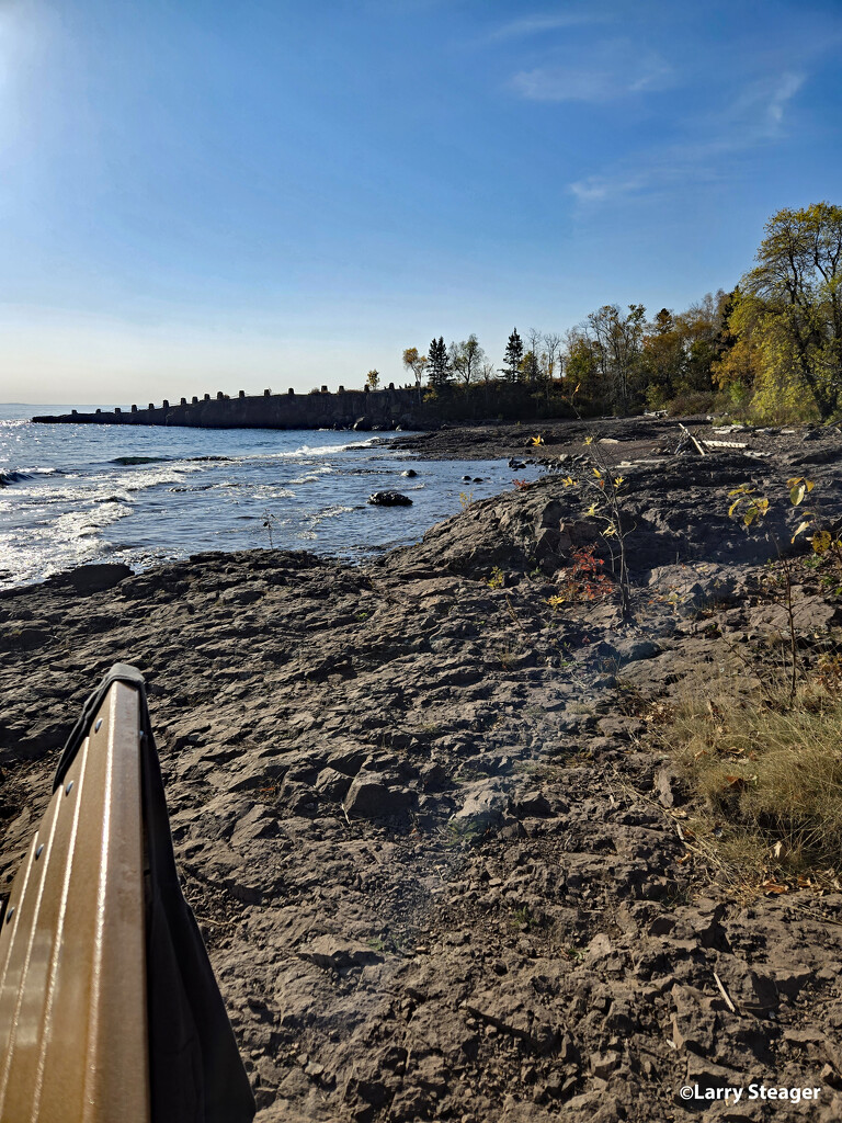 Sitting on a bench along the shore by larrysphotos