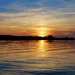 The sun sets behind Howe Island