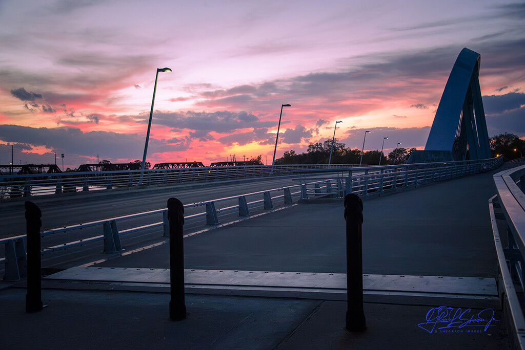 Sun sets over Main St. bridge by ggshearron