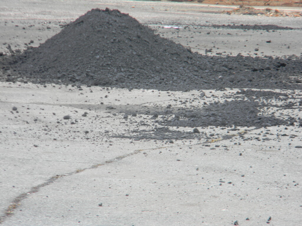 Mound of Asphalt in Parking Lot by sfeldphotos