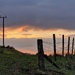 fence and pylon at sunset by christophercox