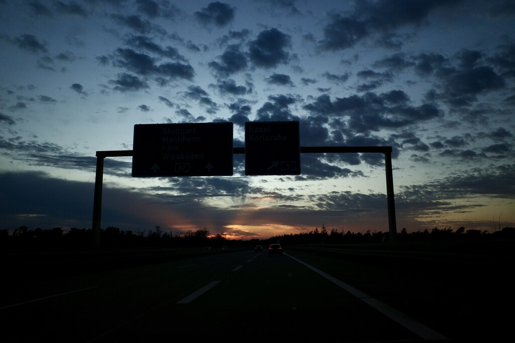 Sunset under the road sign by vincent24