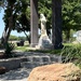 I’m going with “the boulder is juxtaposed in front of the monument”. 