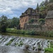A house by a weir on a river in Aveyron by laroque