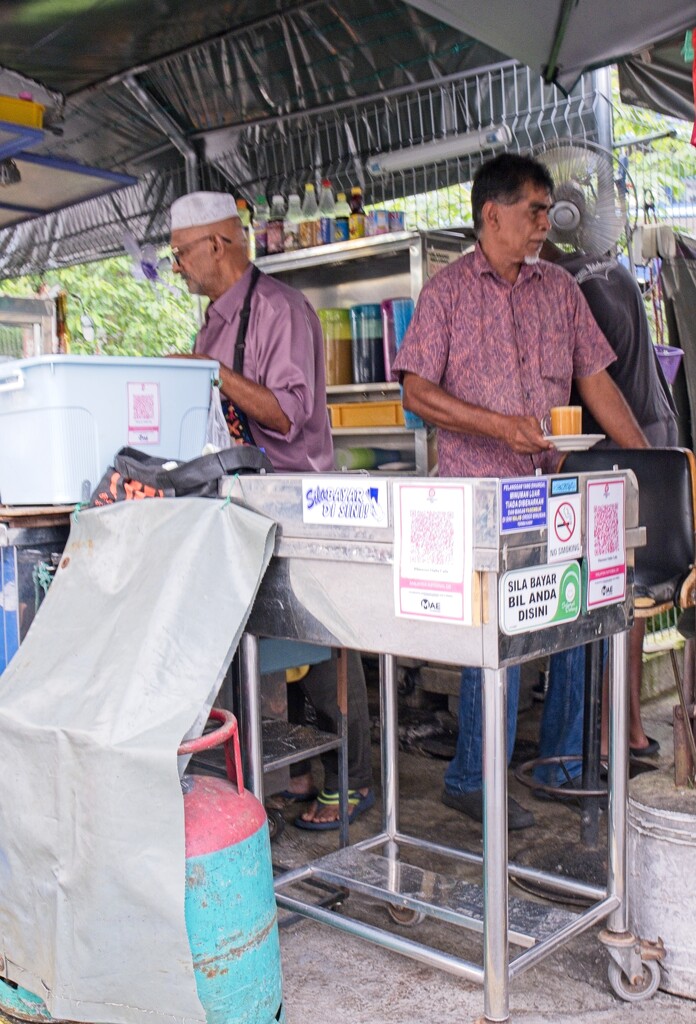 Preparing breakfasts at Roti Bakar, Union Street by ianjb21